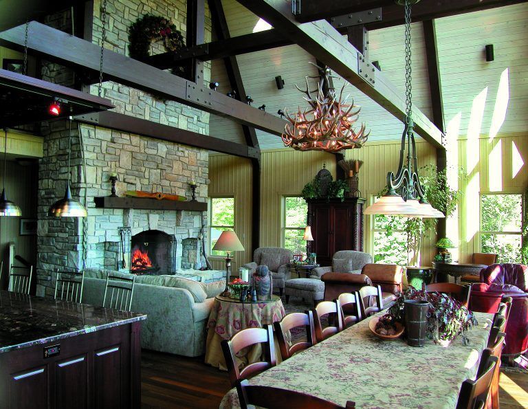 A living room with a fireplace and a long table.