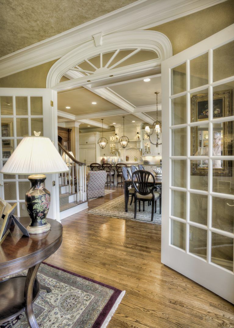 A living room with french doors leading to a dining room.