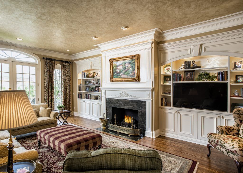 There is a fireplace in the middle of the living room.