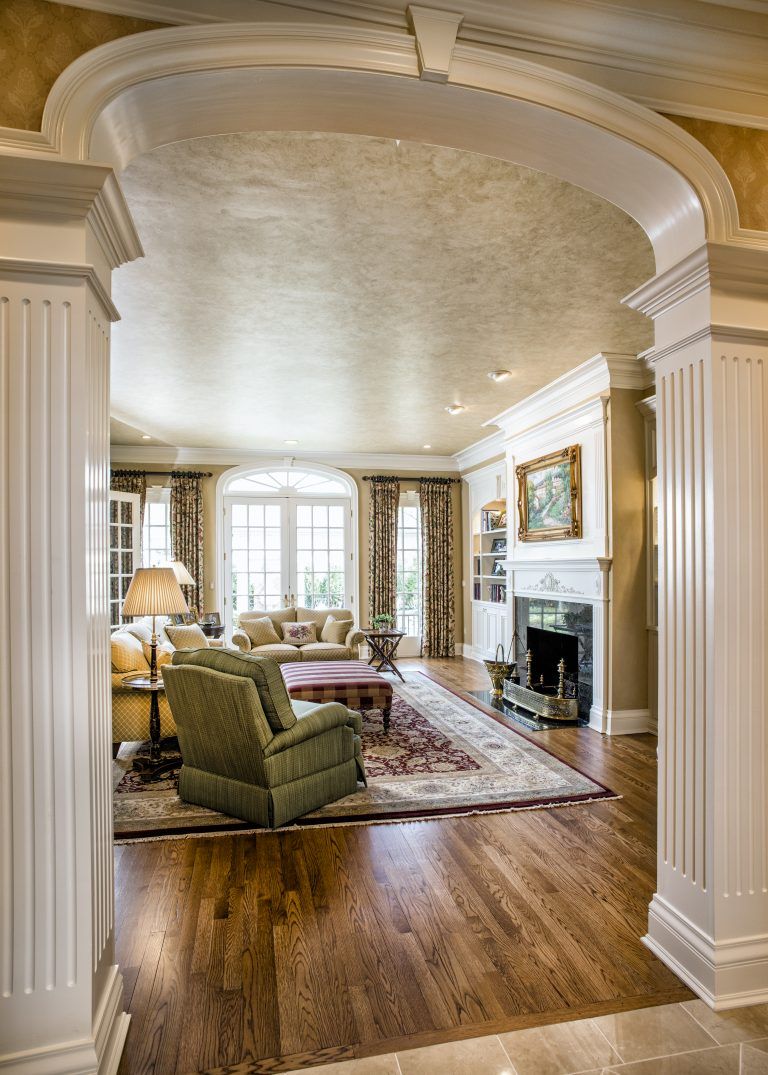 A living room with hardwood floors and a fireplace.