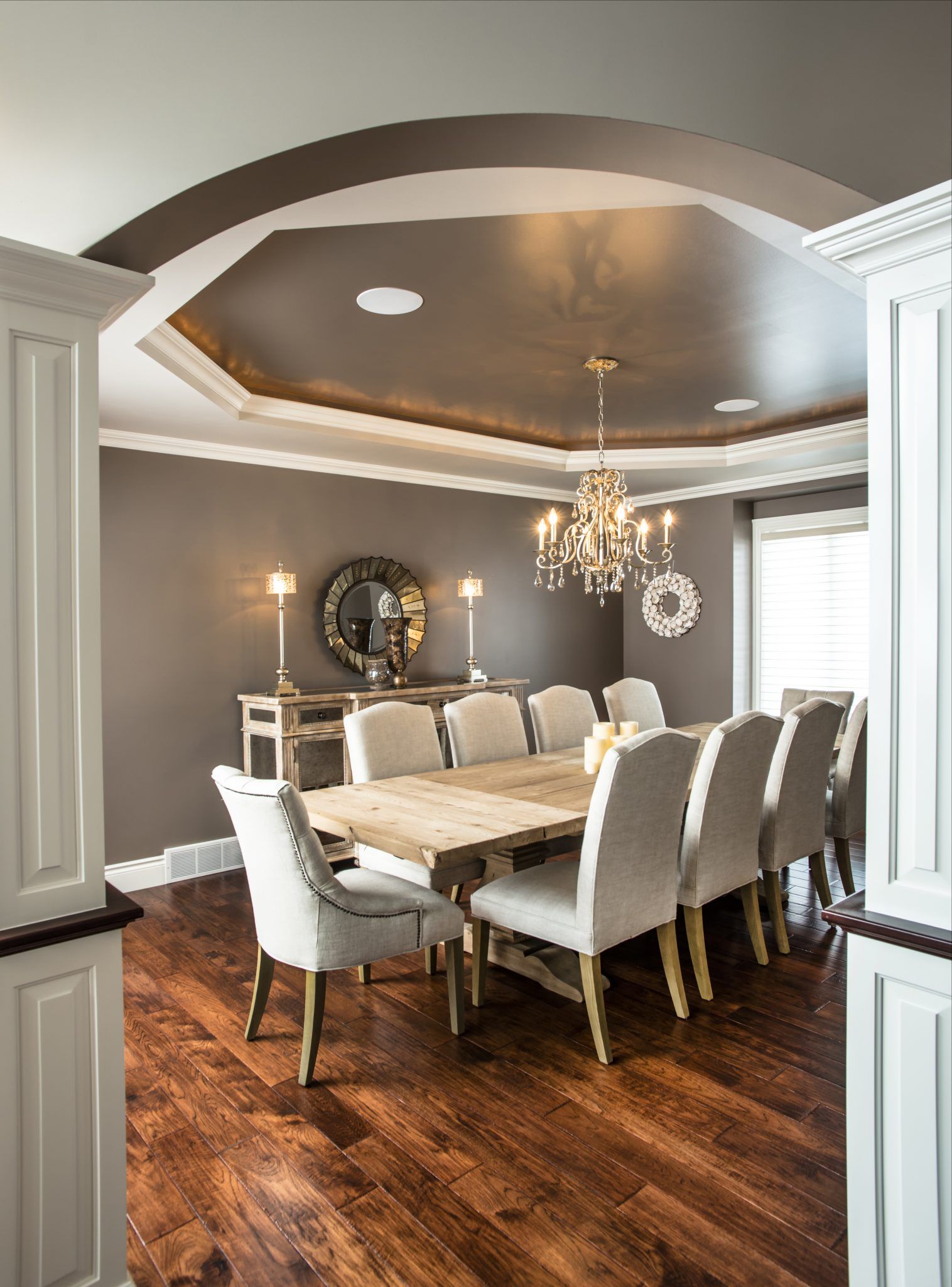 A dining room with a table and chairs and a chandelier.