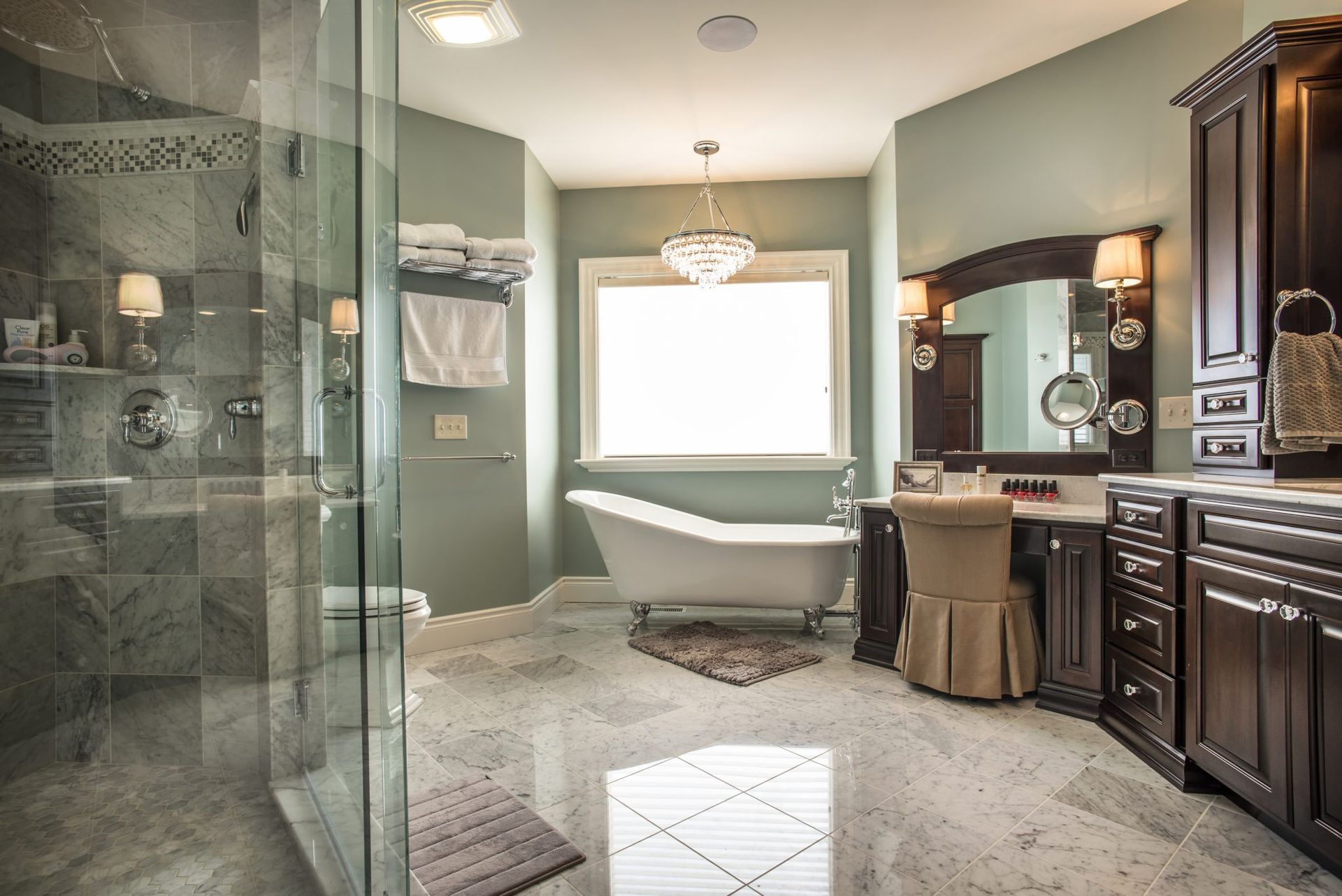 A bathroom with a claw foot tub and a walk in shower