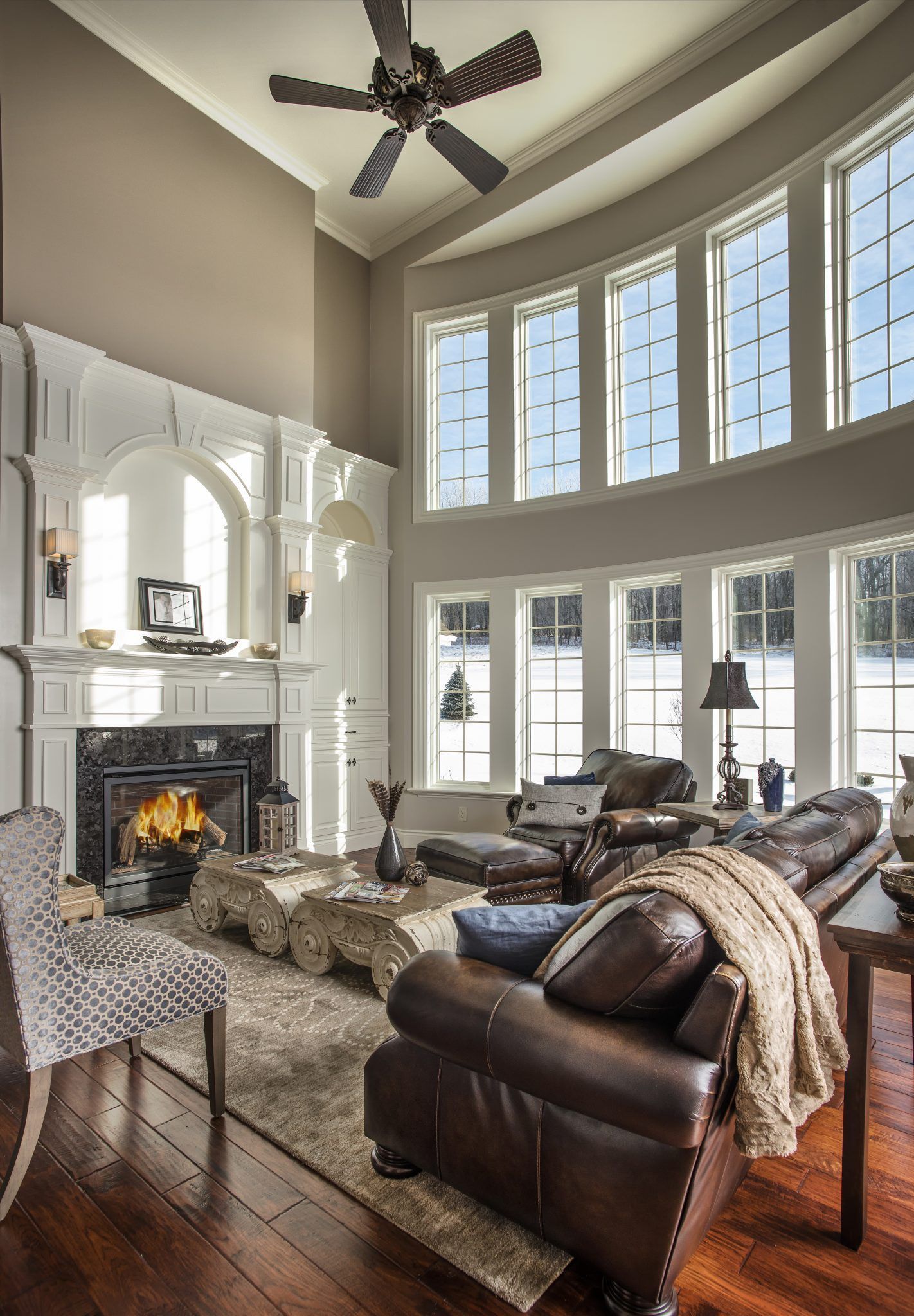 A living room with a fireplace and lots of windows.