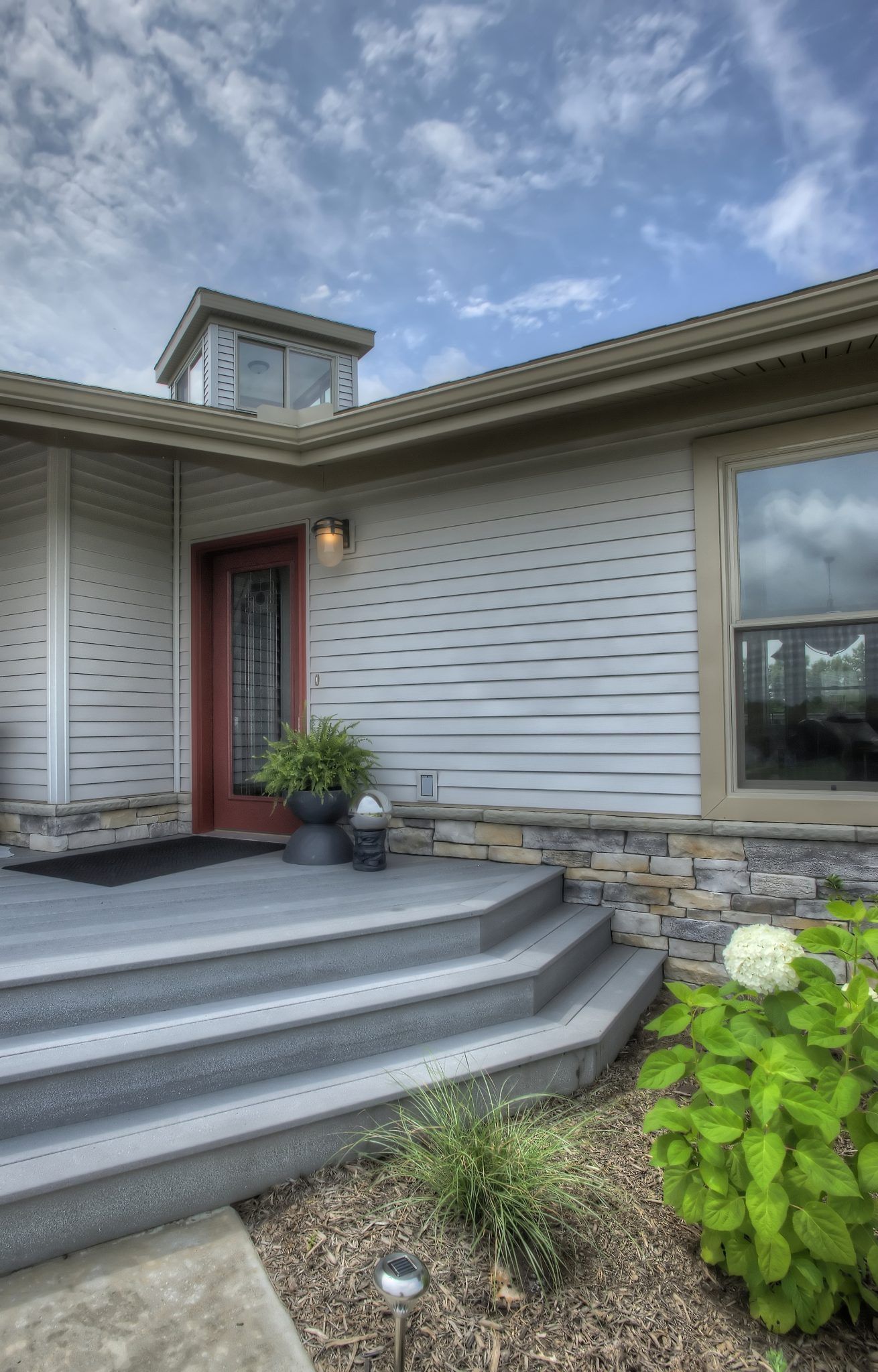 A house with stairs leading up to the front door