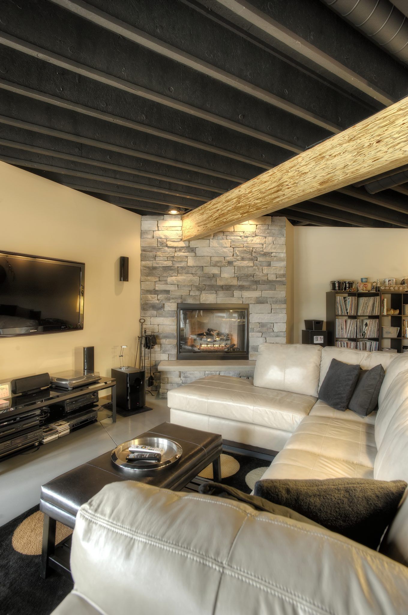 A living room with a couch a fireplace and a flat screen tv