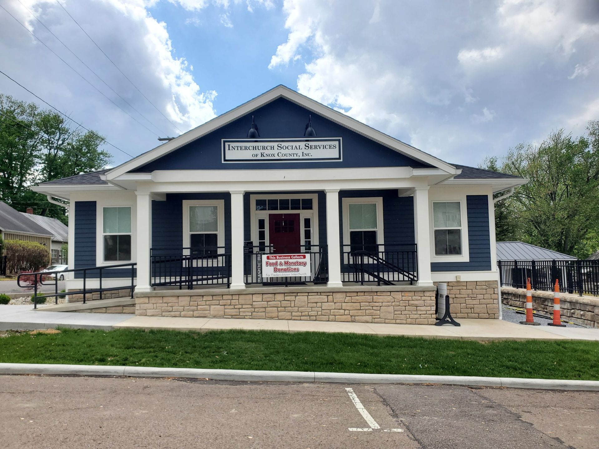 A blue and white house with a red door.