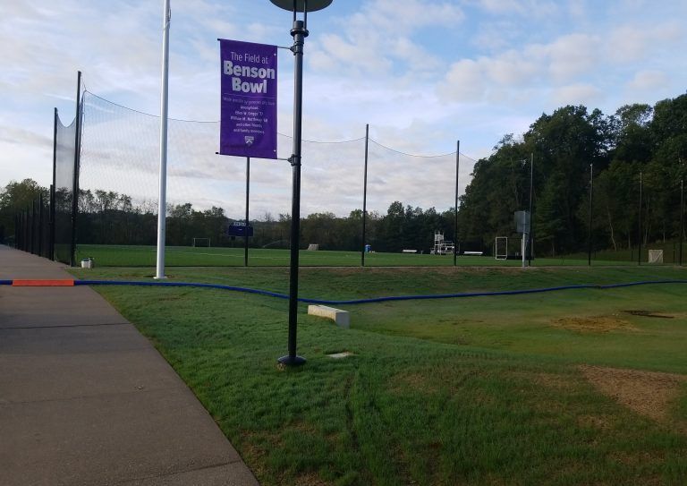 A sign on a pole that says ' Miami Bowl ' on it.