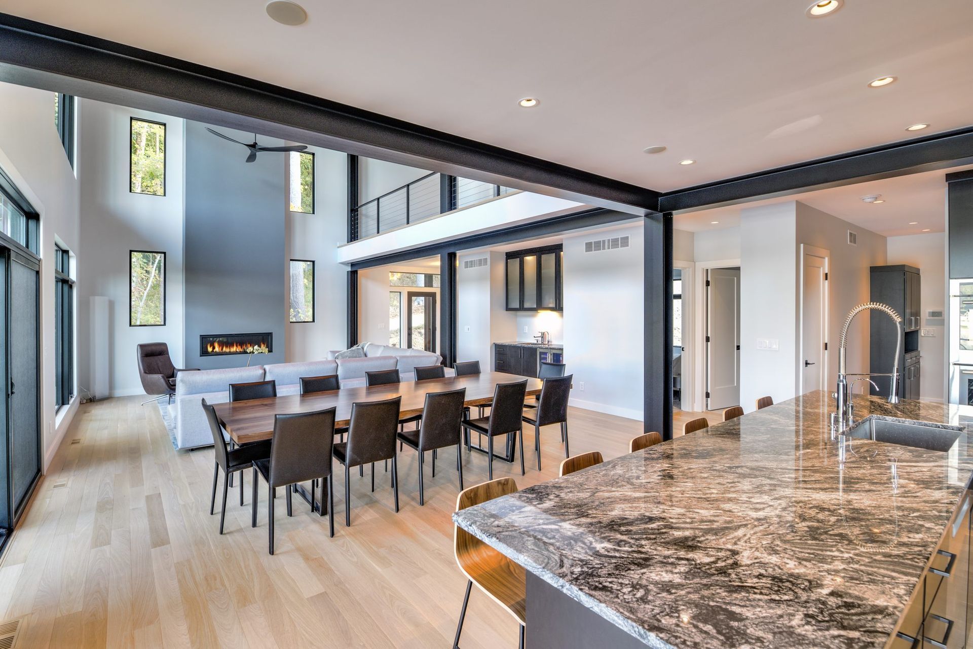 A large living room with a dining table and chairs and a kitchen.