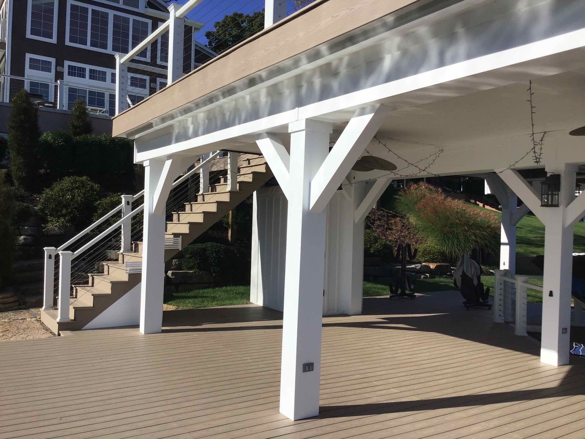 A covered deck with stairs leading up to it.