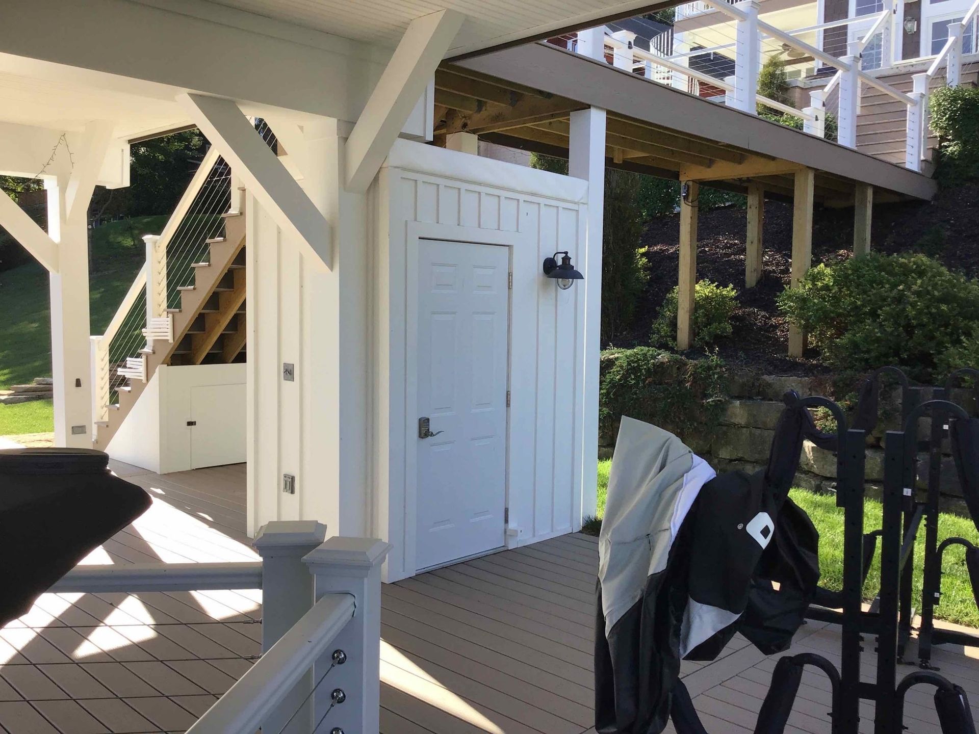 A white building with a staircase behind it.