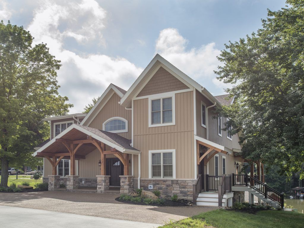 A large house with a porch and a lot of windows.