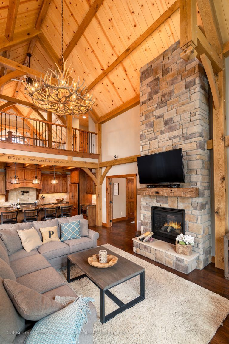 A living room with a couch, fireplace and television.