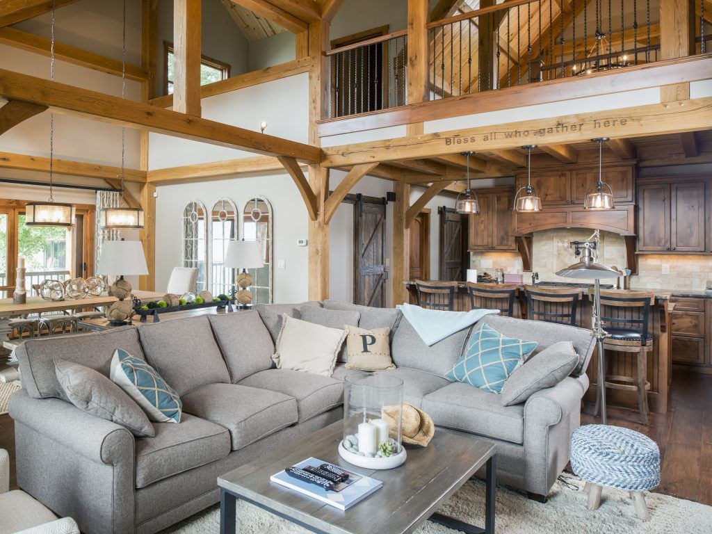 A living room with a large sectional couch and a coffee table.