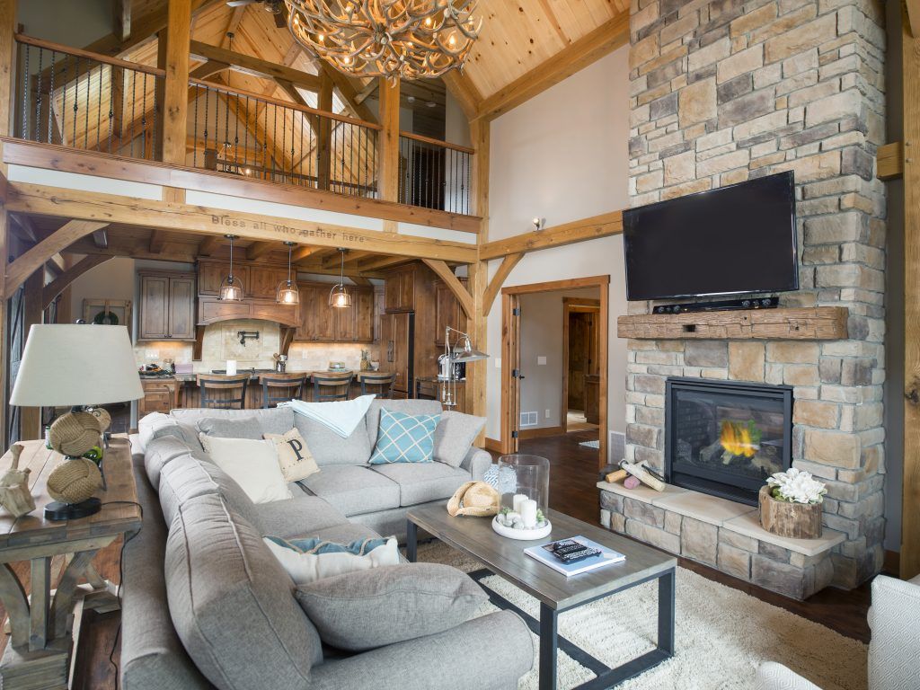 A living room with a couch , fireplace and television.