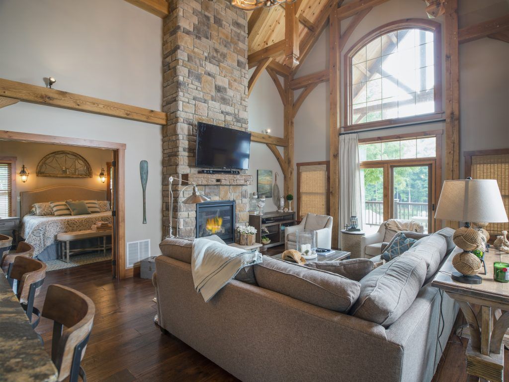A living room with a couch, fireplace, and a television.
