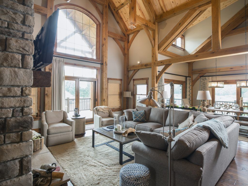 A living room with a couch, chairs, coffee table and television.