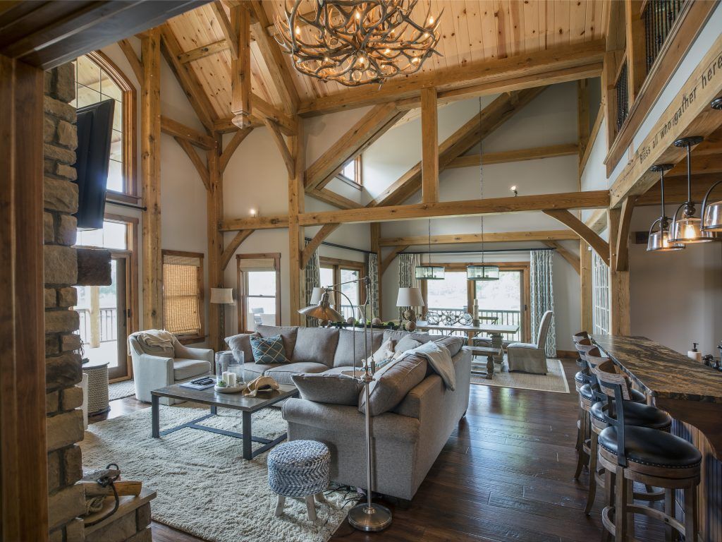 A living room with a couch, table, chairs and a chandelier.