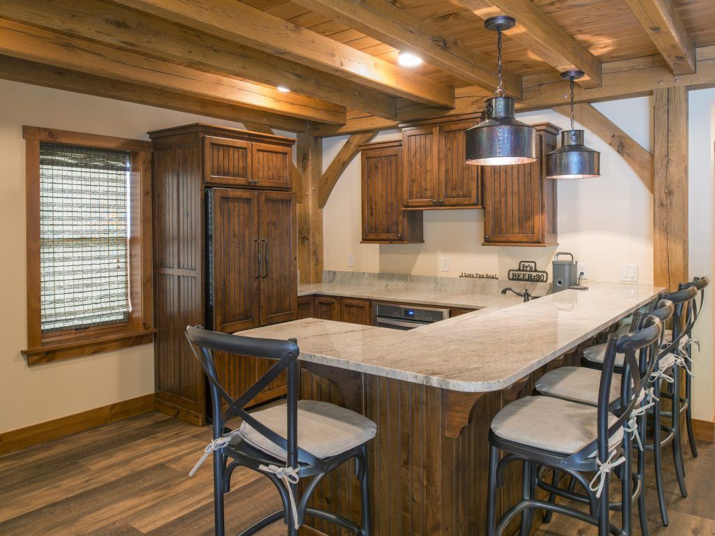 A kitchen with wooden cabinets and a granite counter top.
