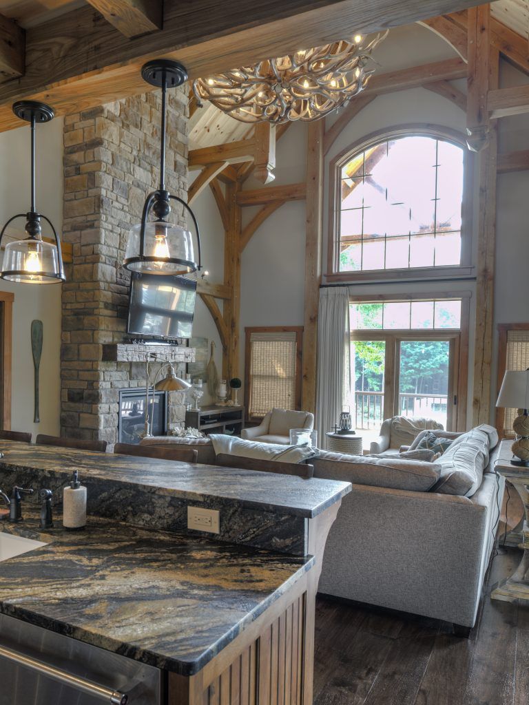 A living room with a couch, a fireplace, and  a table. 