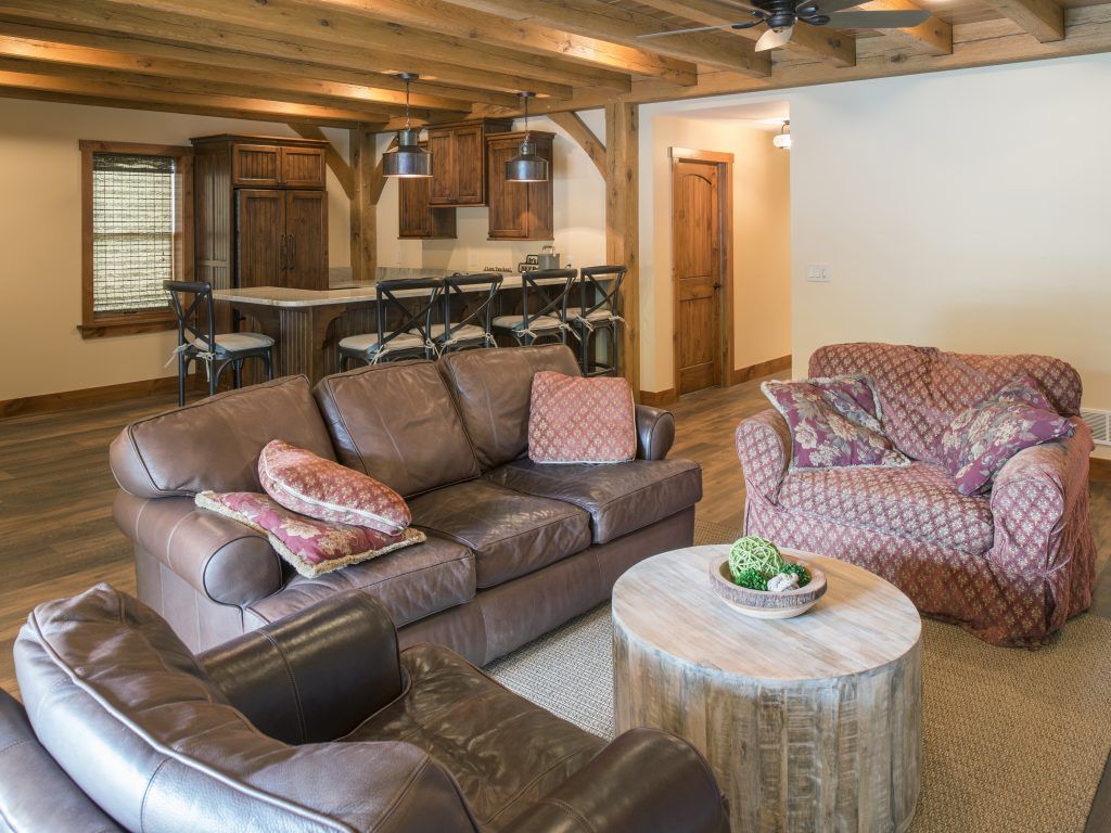 A living room with a couch , chair , and coffee table.