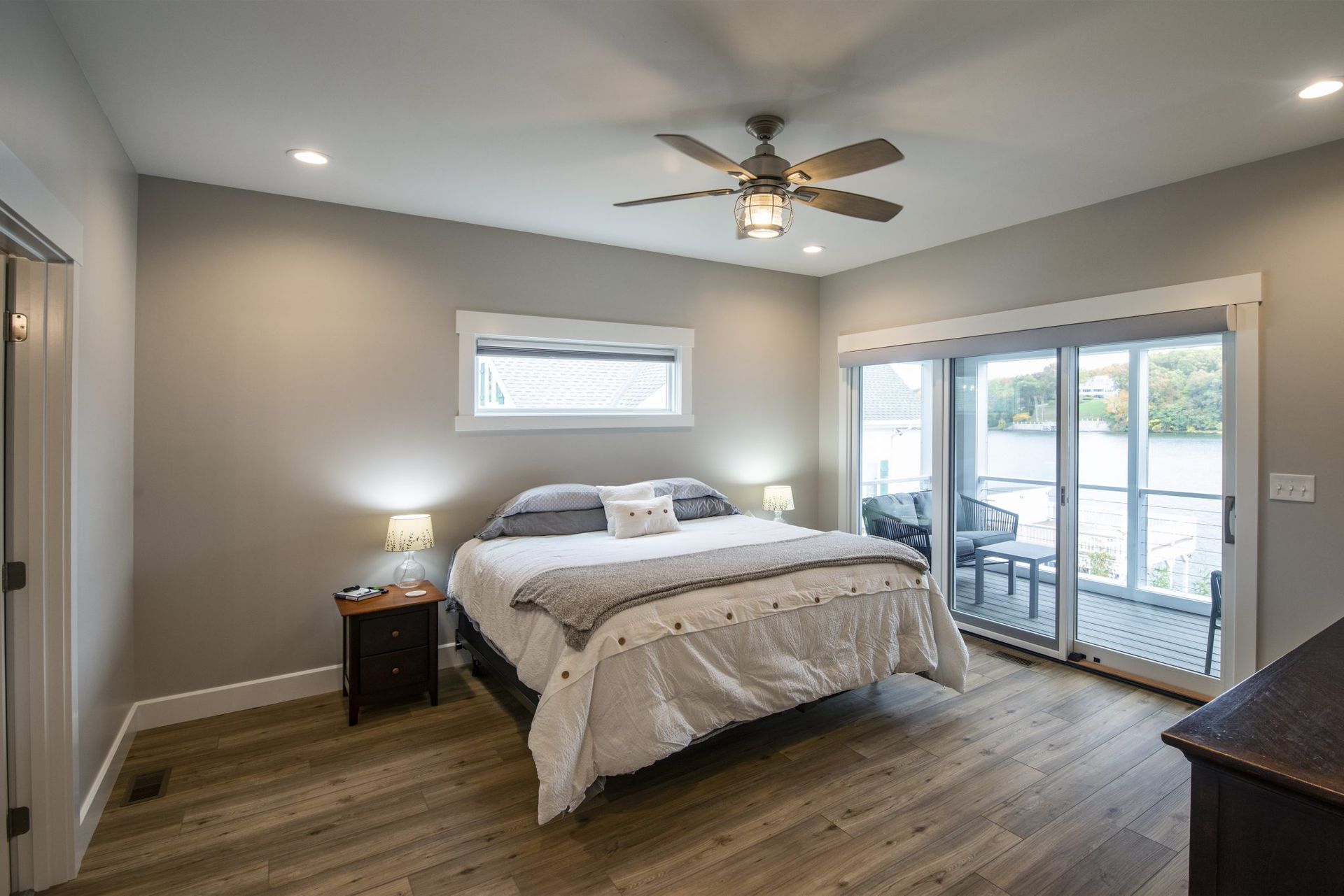 A bedroom with a large bed and a ceiling fan.