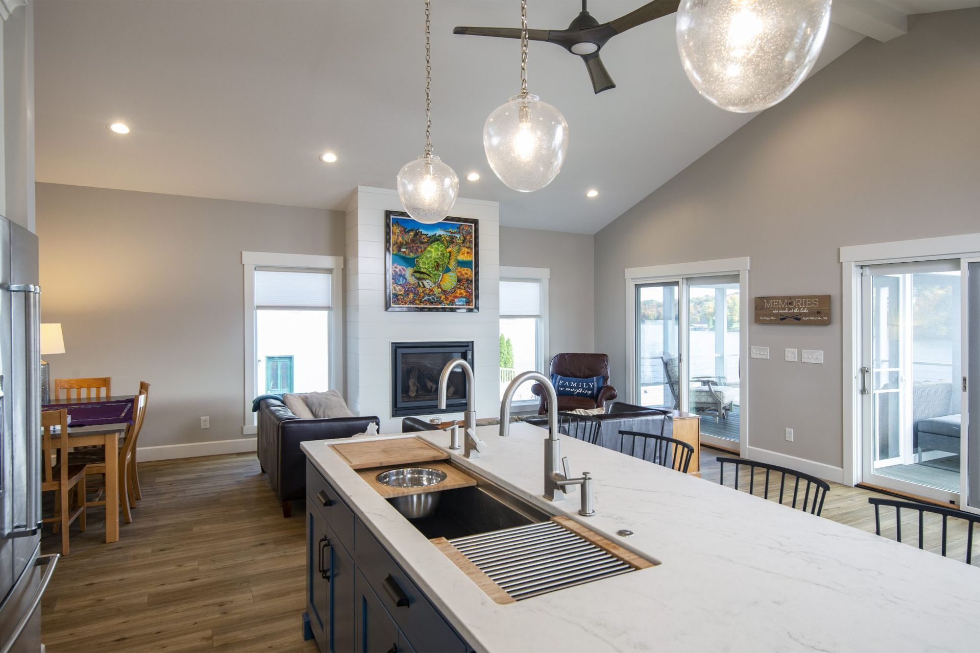 A kitchen with a large sink and a ceiling fan.