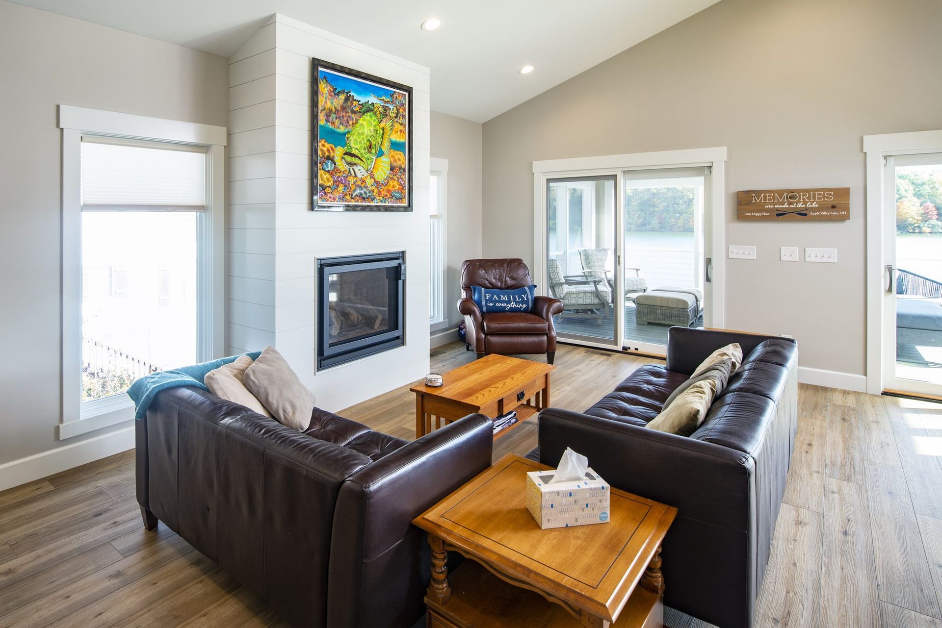 A living room with a couch, chair, coffee table, and fireplace.