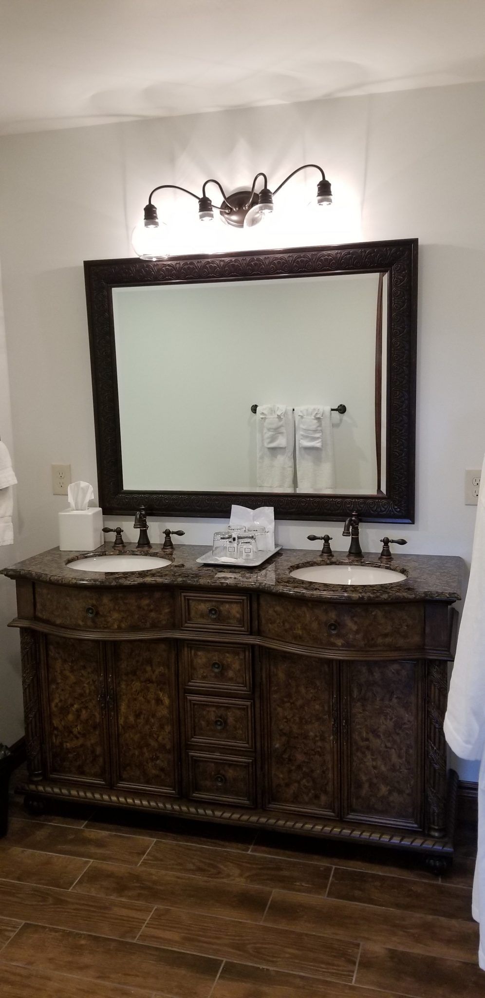 A bathroom with two sinks and a large mirror.