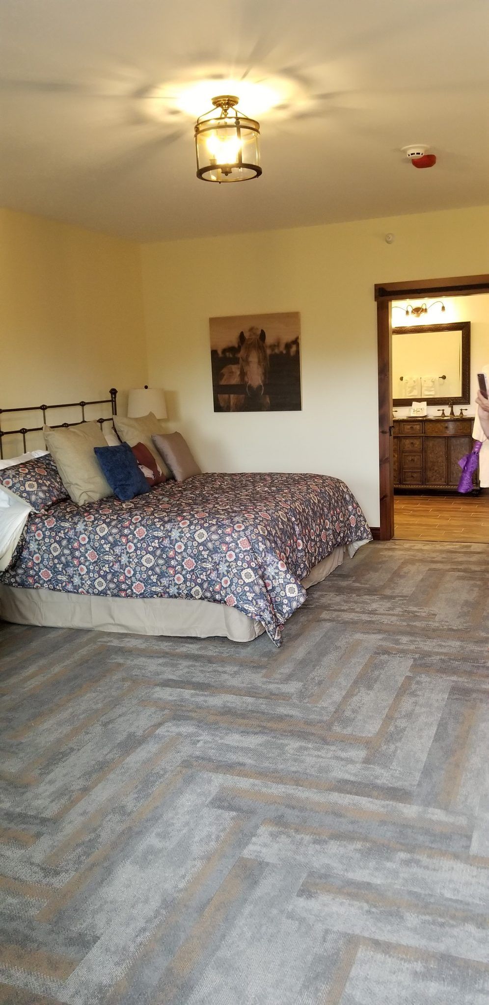 A bedroom with a large bed and a ceiling fan.