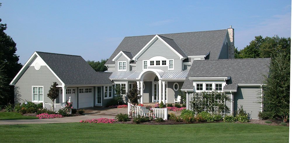 A large house with a gray roof and white trim.