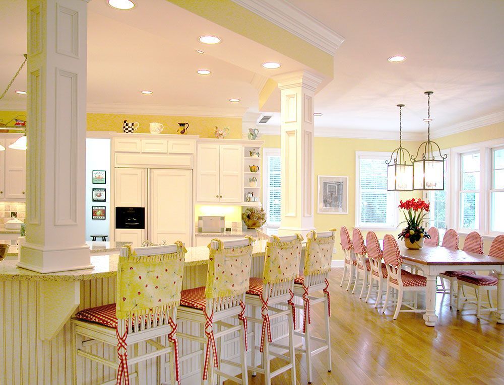 A luxurious kitchen and dining room with a table and chairs.
