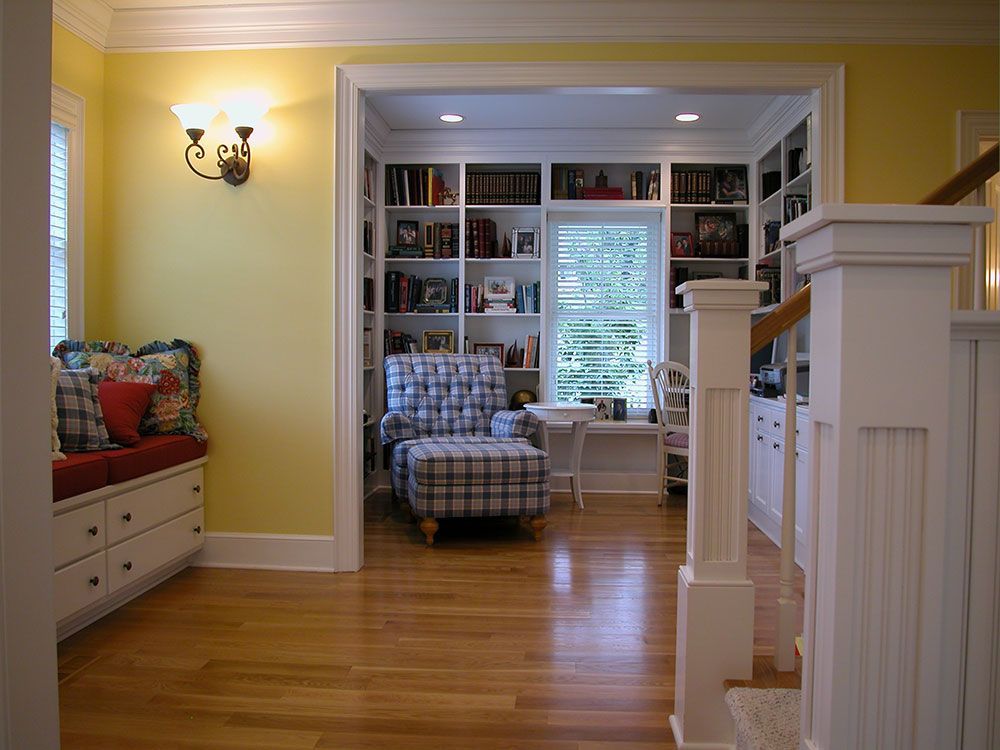 A living room with hardwood floors and yellow walls.