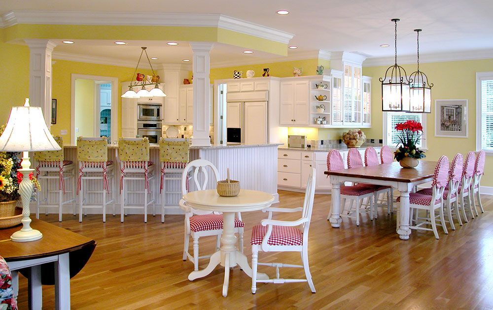 A large room with a table and chairs in it.