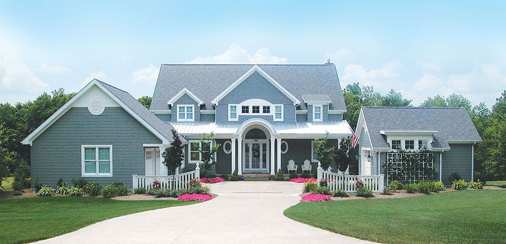 A large house with a driveway leading to it.