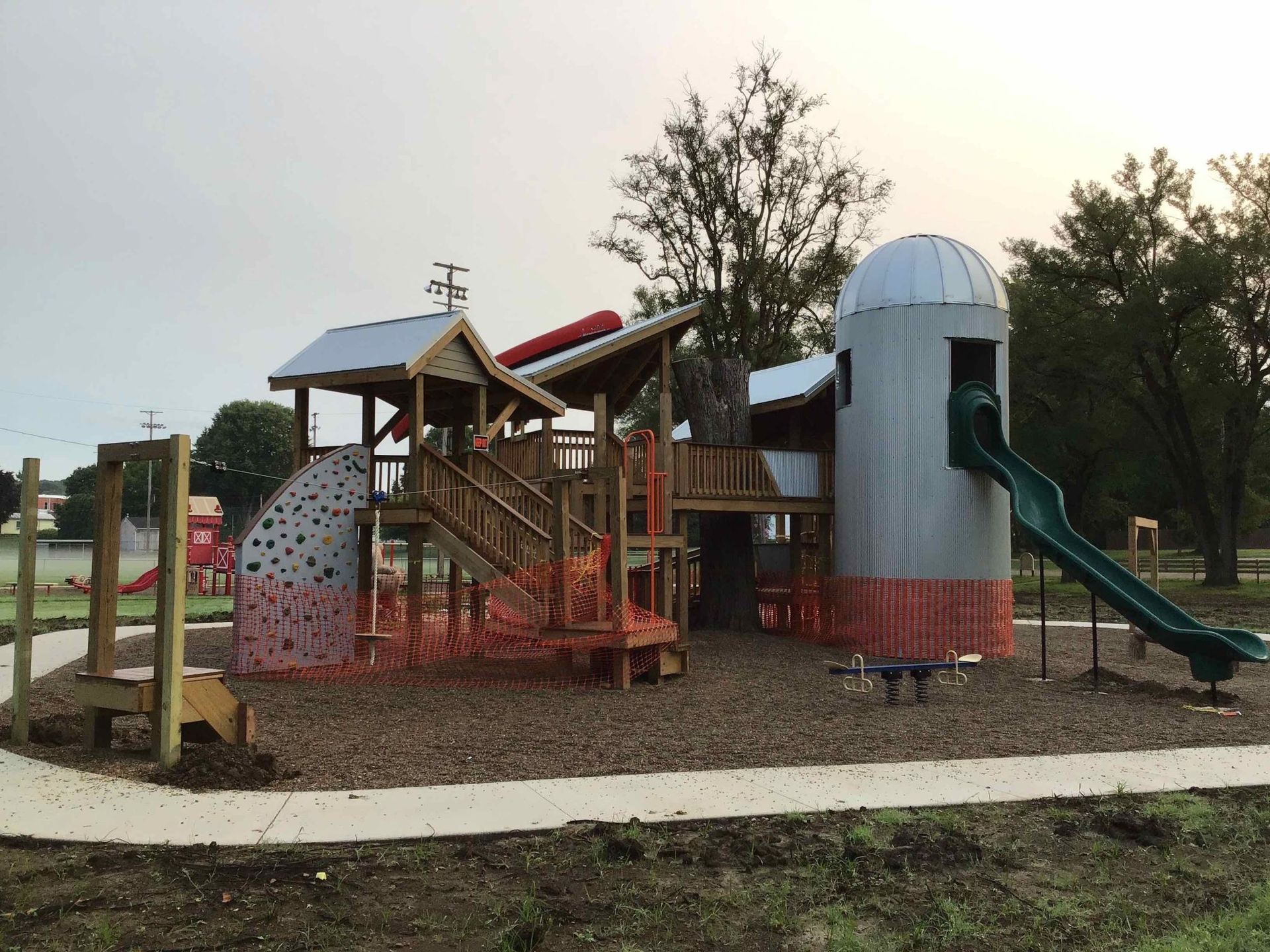 A playground with a silo in the middle of it.