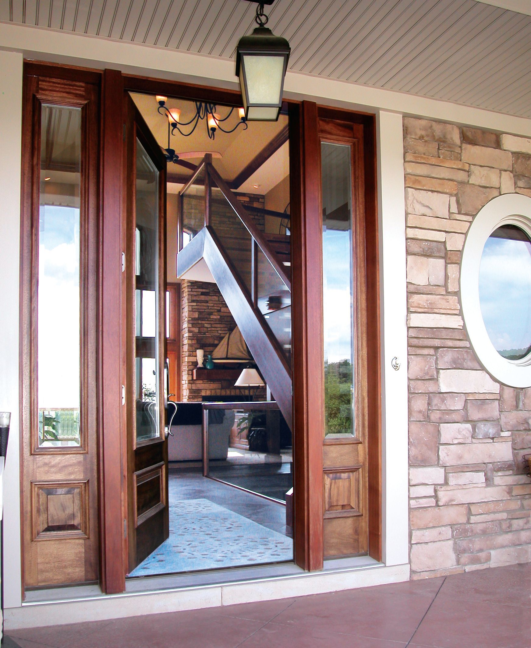 A wooden door is open to a staircase in a house.