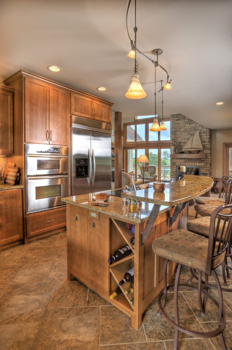 A kitchen with stainless steel appliances and wooden cabinets.