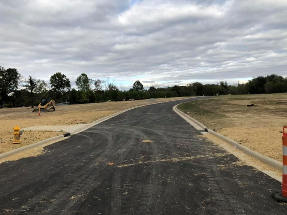 A road with a fire hydrant on the side of it.