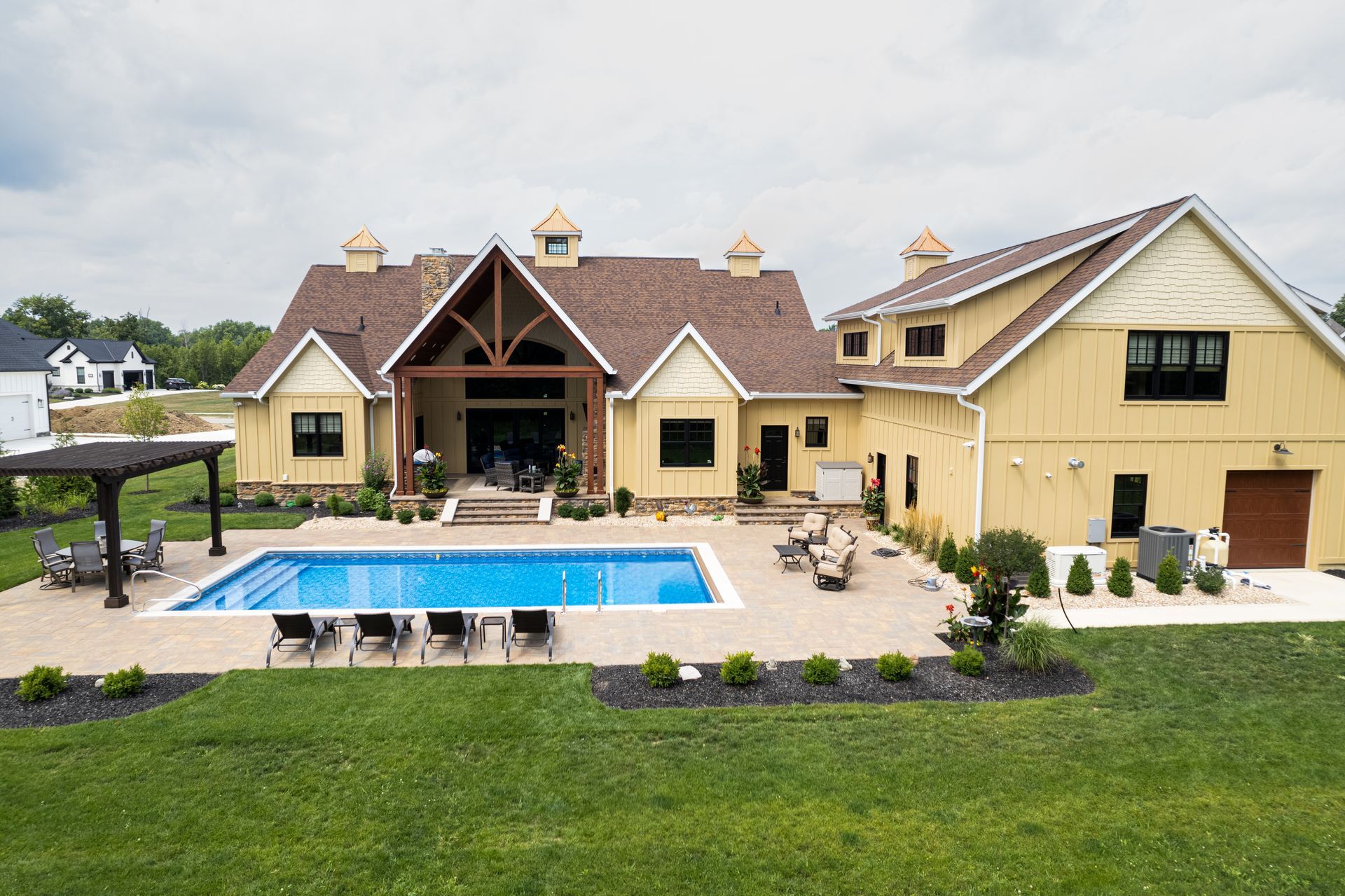 A large house with a large swimming pool in the backyard.
