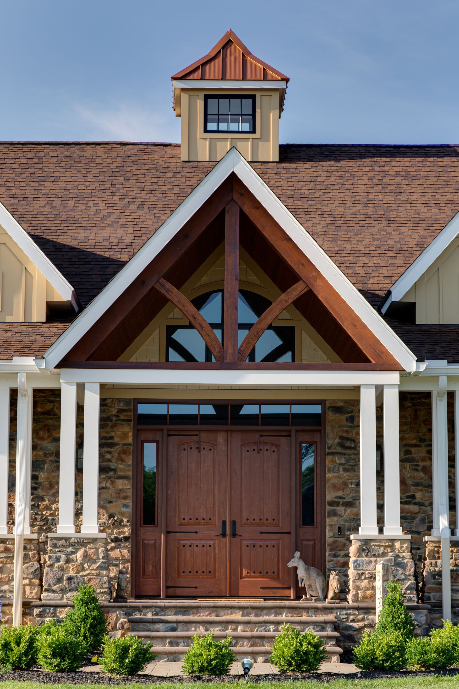 A large house with a wooden door and a roof.