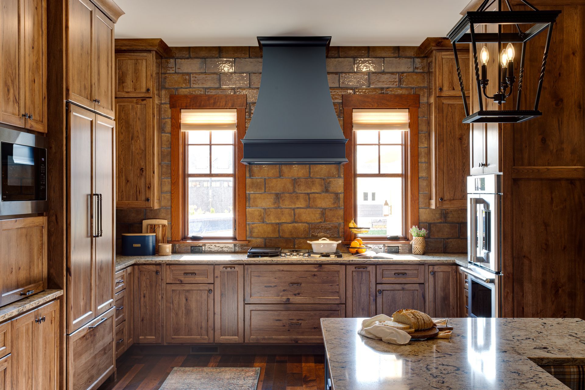 A kitchen with wooden cabinets and granite counter tops.