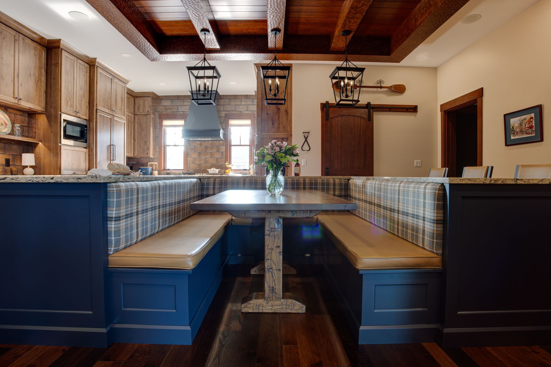 A kitchen with a table and benches in it