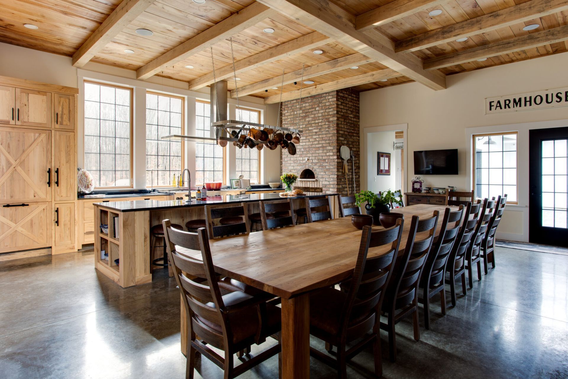 A large dining room with a wooden table and chairs.