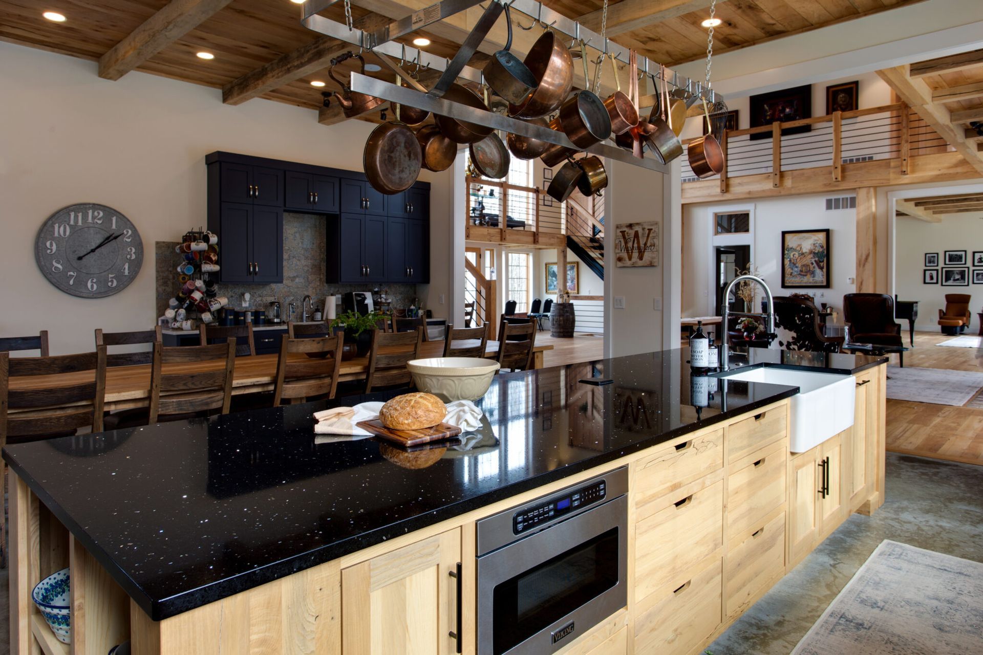 A kitchen with a large island and a clock on the wall.