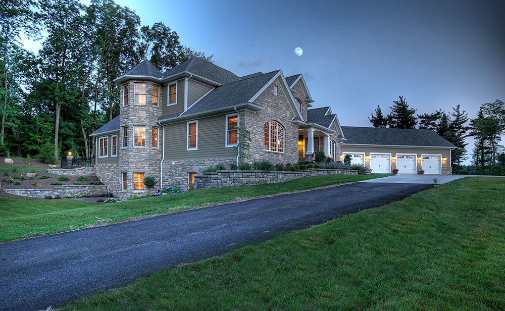 A large house with a driveway leading to it.