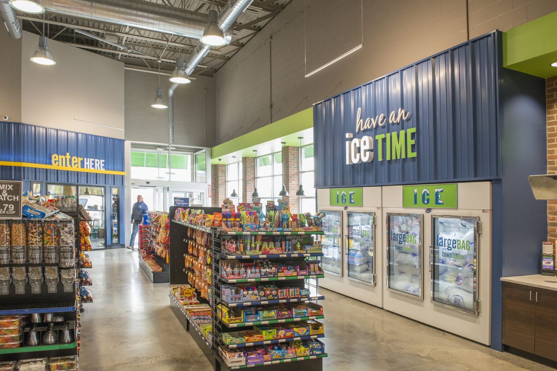 A gas station convenience center with a sign that says ice time.