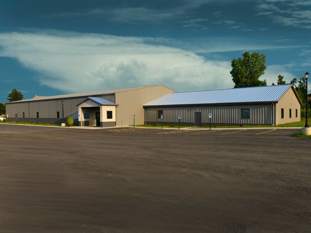 A large building with a parking lot in front of it.