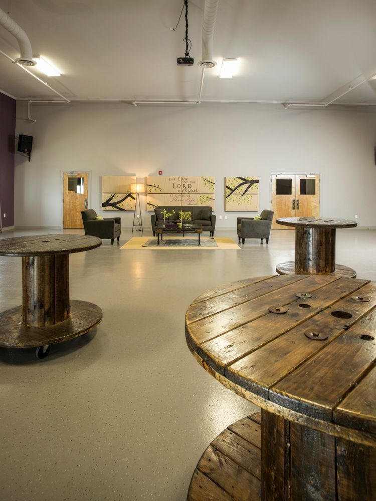 A large room with wooden spools and tables in it.
