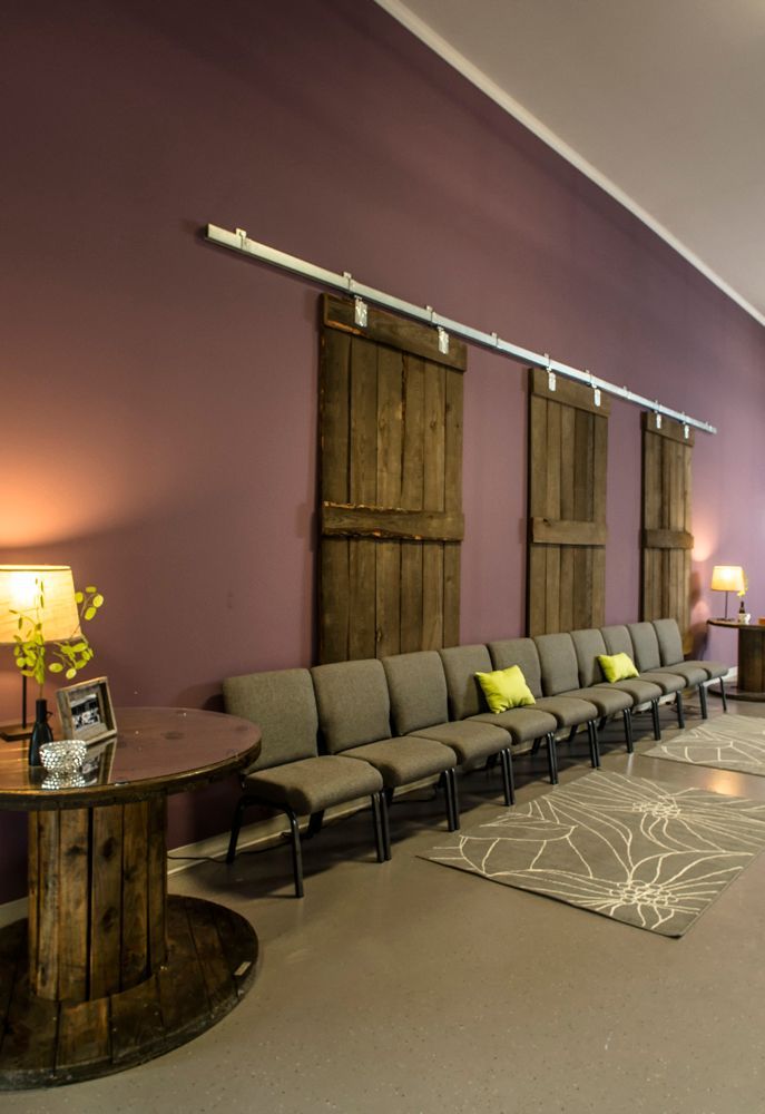 A room with purple walls and sliding barn doors.