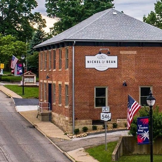 A brick building with a sign that says nickel & bean.